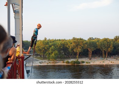 Kiev,Ukraine,02 August 2021: Woman Doing A Bungee Jump From The Bridge Under River Dnepr In Summer Time.
