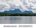Kiew Kho Ma Dam with big mountain and forest, Wide lake with blue sky and white puffy clouds background, Located on Ban Huai Sanao Village, Pong Don, Chae Hom District, Lampang, Northern of Thailand.