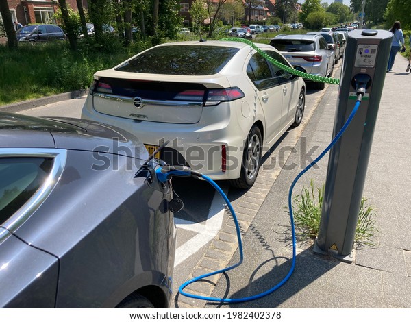 Kijkduin, the Netherlands - May 30 2021:\
Modern electric car charging batteries at plug in charge station in\
the Netherlands