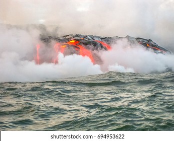 Kilauea Volcano, Also Kilauea Smile Because From 2016 Seems To Smile, Erupting Lava Into Pacific Ocean, Big Island, Hawaii. View From The Boat Of Lava Rivers Into The Sea. Kilauea Erupting Since 1983.