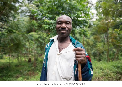 Kilembe, Uganda - October 22, 2016: Portrait Of African Herder Posing With Green Vegetation In The Background