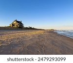 Kilkare, a legendary oceanfront Hamptons mansions in Wainscott, East Hampton, New York.  Holden lighting from a setting sun.