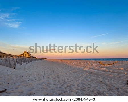 Kilkare mansion at sunset, historic oceanfront home in Wainscott, East Hampton, New York.  Sand dunes, empty beach.