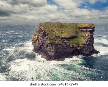 Kilkee cliff in county Clare, Ireland. Popular travel area with stunning nature scenery with green fields, ocean and dramatic sky. Irish landscape. Rough coast line. Warm sunny day. - Powered by Shutterstock
