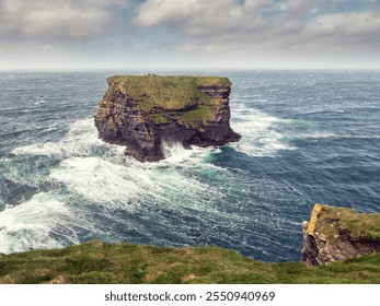 Kilkee cliff in county Clare, Ireland. Popular travel area with stunning nature scenery with green fields, ocean and dramatic sky. Irish landscape. Rough coast line. Warm sunny day. - Powered by Shutterstock