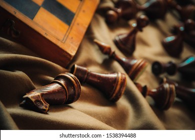 killed chess pieces lie near the chessboard, vintage chess wooden chess pieces, textured chess pieces, the end of the game, defeated