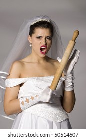 Killer bride photo series. Bridezilla with wooden rolling pin. Studio shot