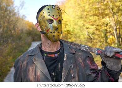 Killer with wooden ax in the forest