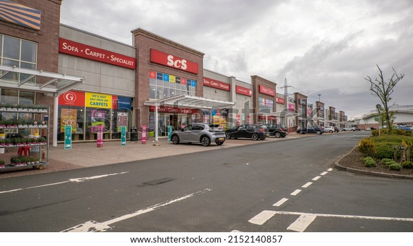 Kilmarnock, East Ayrshire, Scotland, UK - May\
2nd 2022:Line of popular Scottish retail stores in Queen\'s Drive\
Retail Park Kilmarnock, East\
Ayrshire.