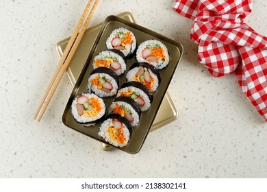 Kimbap - Korean seaweed rice roll filled with a variety of delicious fillings, egg, carrot, ham, tuna, shrimp, cheese, gochujang sauce and pickled radish, served with kimchi, The street food of Korea. - Powered by Shutterstock