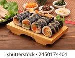 Kimbap is a Korean-style nori roll, which is rolled with rice mixed with sesame oil, salt, and other ingredients on top of nori.