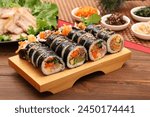 Kimbap is a Korean-style nori roll, which is rolled with rice mixed with sesame oil, salt, and other ingredients on top of nori.