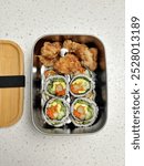 Kimbap or kimbap or nasi gulung with chicken kaarage for simple snack box. Kindergarten lunch box. Selective focus. Little noise and grainy.