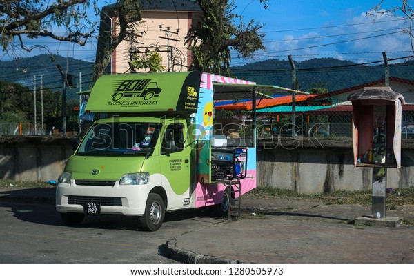 Kinarut , Sabah,  Malaysia\
\
January 10, 2019\
\
Ice cream truck parked by abandoned phone\
booth