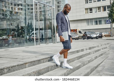 Kind Bearded Businessman Carrying Laptop While Going Downstairs To The Pavement