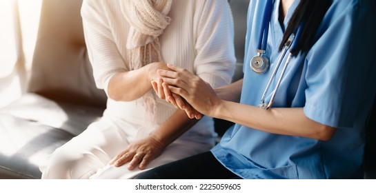 Kind Nurse Together With Elderly Woman In The Hospital's Or Home

