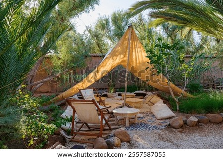 Kind of tepee tent between the trees on a small, green and luxury resort in Skoura, Morocco