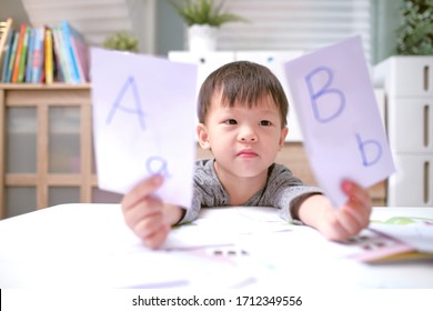 Kindergarten boy playing with flash cards , Asian children learning English with flash cards, Teach young kids English at home, Child at home, kindergarten closed during the Covid-19 health crisis - Powered by Shutterstock