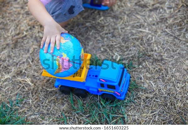 Kindergarten children play toys\
and balls Happily and joyfully on a clear day, feeling a good\
future.