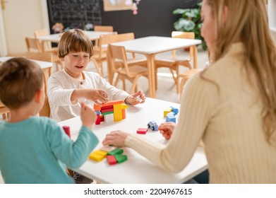 Kindergarten Children Playing With Colorful Building Blocks. Healthy Learning Environment. Learning Through Play.
