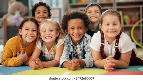 Kindergarten, kids and face with smile on floor for education, knowledge and learning at academy. Students, friends and happy with diversity in school for child development, scholarship and bonding