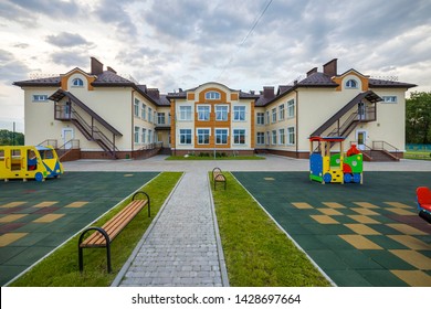 Kindergarten preschool building with big windows. Architecture and development concept.