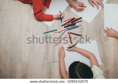 Kindergarten and preschool Kids and teacher drawing,painting on paper learning colorful education top view with copy space.