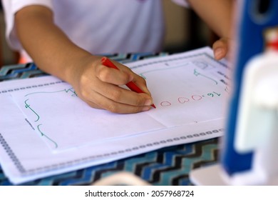 A Kindergarten Student Is Drawing Circle Shapes In An Online School Via Smartphone During The Covid-19 Pandemic