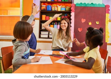 Kindergarten Teacher And A Child At High Five In A Painting Course In Preschool Or Kindergarten