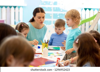 Kindergartener Teaches Children Handcraft At Nursery Or Playschool