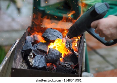 Kindling Coals For A Barbecue With An Industrial Hot Air Gun