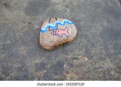 Kindness Rock With Cute Small Fish Holding Fake Shark Fin