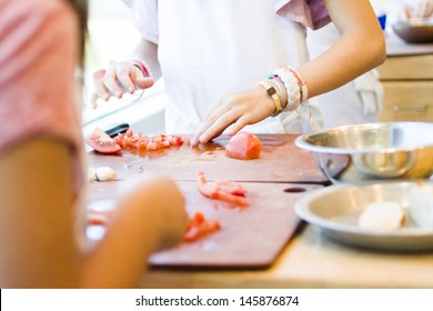 Kinds In Cooking Class Making Bruschetta.