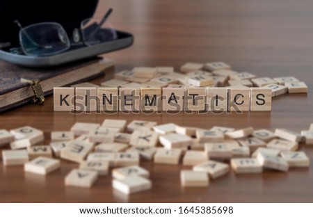 kinematics concept represented by wooden letter tiles