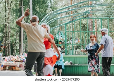 Kineshma, Russia - July, 2021: Active Happy Seniors, People Dancing In Central Park To The Sounds Of A Live Orchestra, Young At Heart, Active Old Age, Lifestyle Concept. 