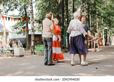 Kineshma, Russia - July, 2021: Active Happy Seniors, People Dancing In Central Park To The Sounds Of A Live Orchestra, Young At Heart, Active Old Age, Lifestyle Concept. 