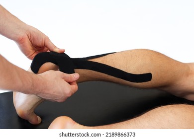 Kinesiology taping treatment with black tape on male patient injured Achilles tendon. Sports injury kinesio treatment.	 - Powered by Shutterstock