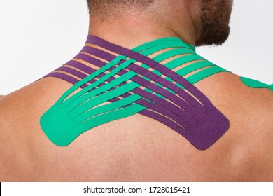 Kinesiology taping.Close up view of kinesiology tape on patient neck.Young male athlete on white background.Post traumatic rehabilitation,sport physical therapy, recovery concept,alternative medicine. - Powered by Shutterstock