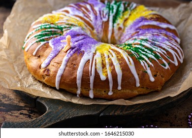 King cake for Mardi Gras, New Orlean traditional pastry with a plastic baby