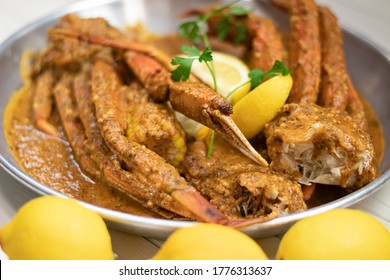 King Crab Legs Cajun Tray With Yellow Lemons.  Restaurant Menu. Hot And Spicy Food. Seafood Plate.