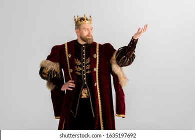king with crown pointing with hand isolated on grey