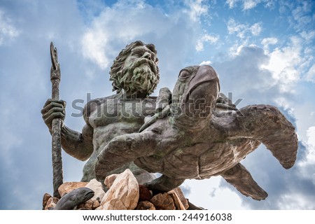 King Neptune statute, famous tourist attraction at Virginia Beach, against a cloudy sky