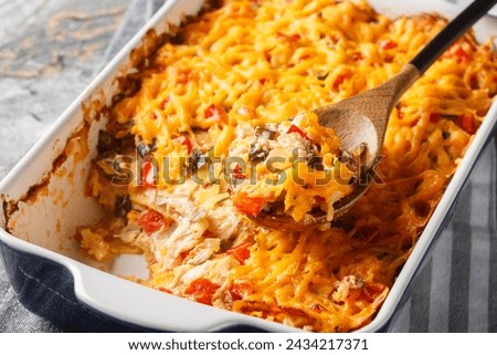 King Ranch Chicken Casserole is a Southern Texas staple dish close-up in a baking dish on a marble table. Horizontal
