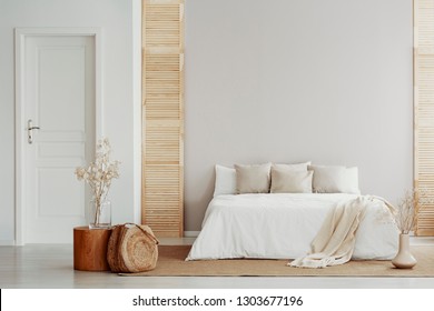 King Size Bed Near To White Door In Natural Style Bedroom For Woman