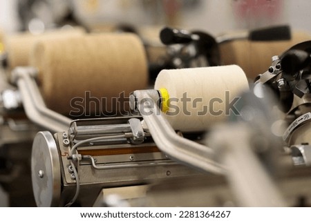 King spool sewing thread winding machine close up. Selective focus.