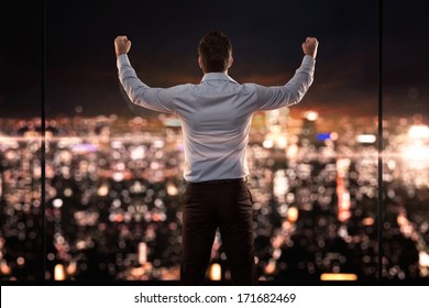 King of the world, young successful businessman in front of the city at night - Powered by Shutterstock