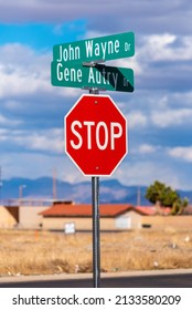 Kingman, United States - March 5, 2022: A stop sign at the intersection of John Wayne and Gene Autry Drives.