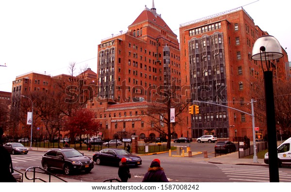Kings County Hospital center Red brick\
buildings with cars in street at dusk located in flatbush Brooklyn\
NY on a cloudy winter evening December 11\
2019