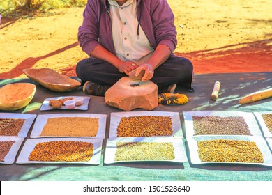 Kings Creek Station, Northern Territory, Australia - Aug 21, 2019: Australian Aborigena Woman Crushes With A Stone Bush Seeds At Karrke Aboriginal Cultural Experience Tour Near Kings Canyon.