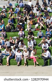 KIngs Cross, London, UK - May 5, 2016.  Crowds Of Office Workers, Colleagues And Friends Gathering Outdoors On A Sunny Day In Summer During A Lunch Break In London, UK